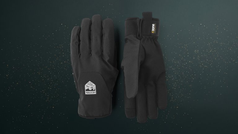 Black Hestra CZone Bike Mistral gloves against a green speckled practical gift guide background