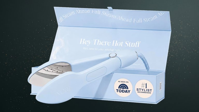 Light Blue Nori Press Travel Steam Iron and box against a green speckled practical gift guide background