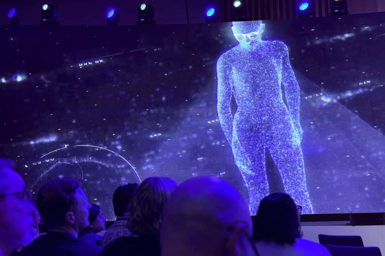 A virtual figure projected on the big presentation screen at the EssilorLuxottica SWITCH eye-care summit in Orlando in March 2026