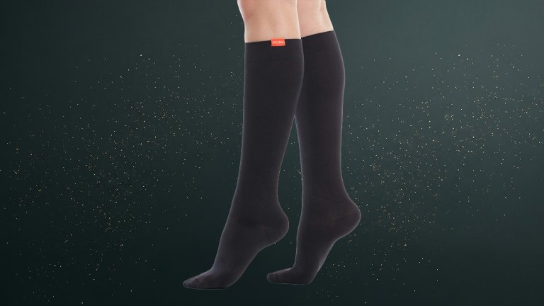 VIM & VIGR 15-20 mmHg Merino Wool Graduated Compression Sock on a green sparkly travel gift guide background