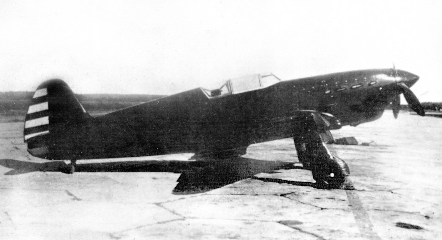 Black and white photo of Yak-1 fighter plane on tarmac