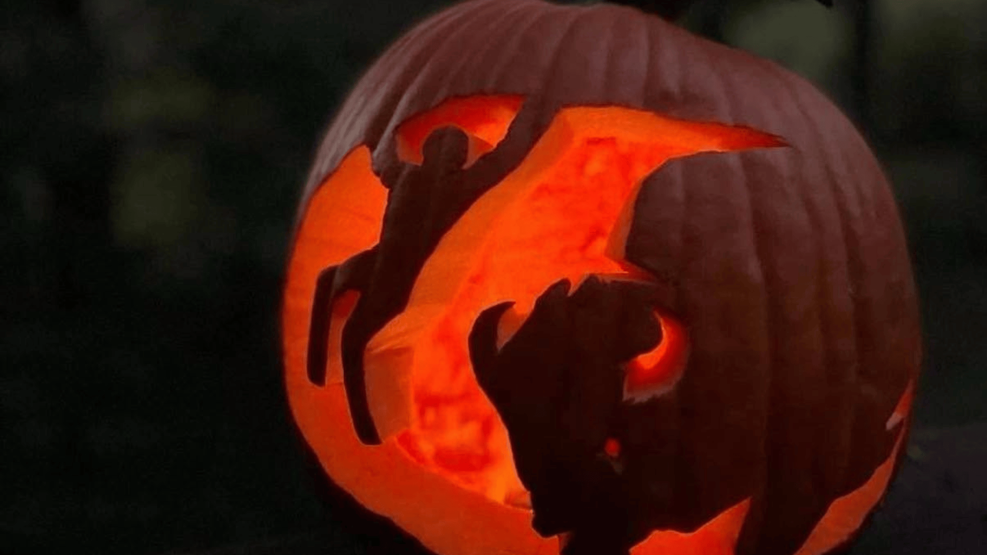 a pumpkin carved to look like a person being bucked by a bison