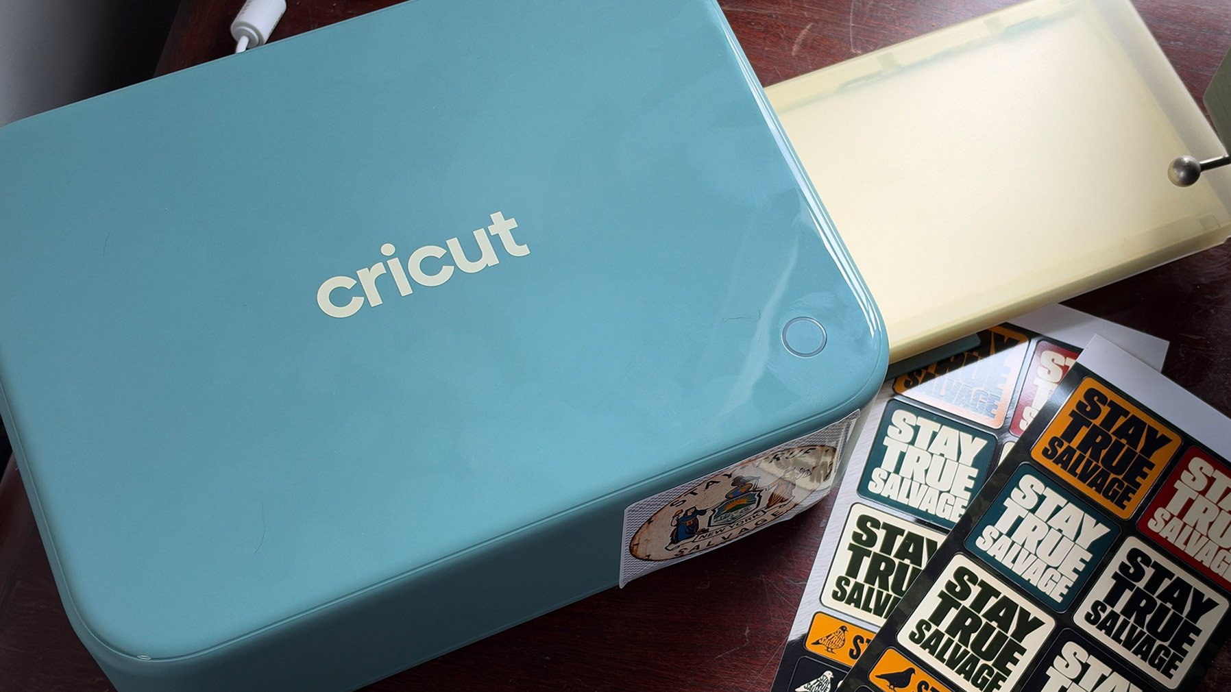 Cricut StickerPix Print + Cut on a desk with stickers