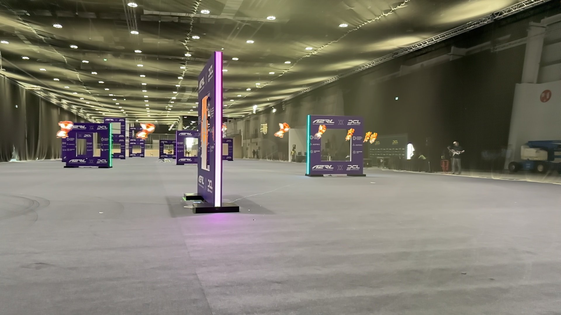 Timelapse image of the autonomous MonoRace racing drone flying through the final racing gate at Abu Dhabi in 2025. Image: Micro Air Vehicles Lab | Delft University of Technology.