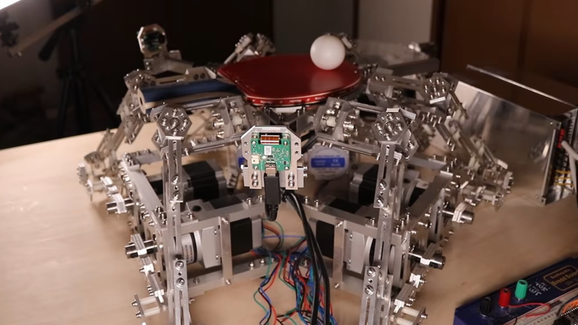 a flat robot with a ping pod paddle and ball