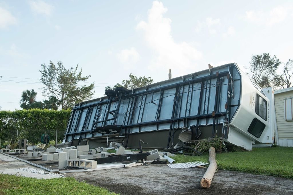 An overturned trailer is seen at the Enchanted Shores manufactured home park in Naples, Florida