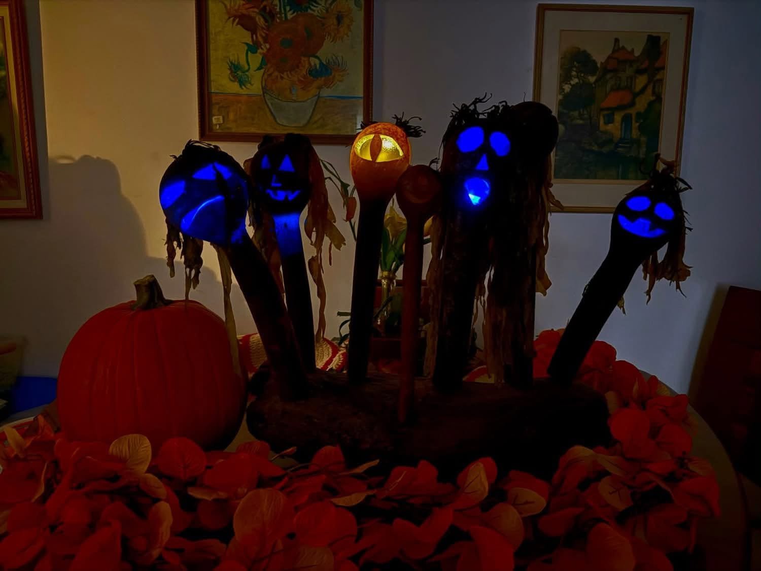 six sculptures made of kelp with blue lights in them