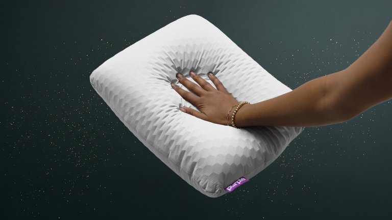 purple harmony anywhere pillow on a green sparkly travel gift guide background